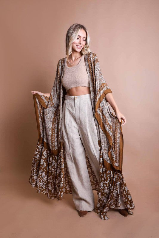 This sheer kimono is your ideal companion when you want to feel like you’re floating through life. Designed for the woman who loves to layer with ease and grace! This free flow Kimono stands out from others as it goes from a minimalist top and transitions beautifully into a rich paisley print as it flows toward the hem, creating a look that’s both modern and timeless. The oversized fit and mid-length sleeves add to the laid-back, breezy vibe, making it the ultimate piece for both lounging and living. 