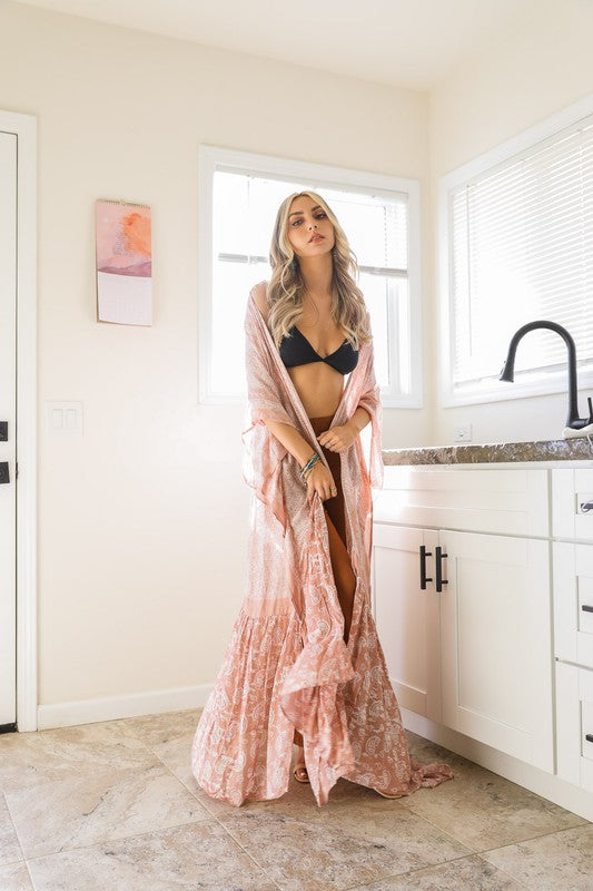 This sheer kimono is your ideal companion when you want to feel like you’re floating through life. Designed for the woman who loves to layer with ease and grace! This free flow Kimono stands out from others as it goes from a minimalist top and transitions beautifully into a rich paisley print as it flows toward the hem, creating a look that’s both modern and timeless. The oversized fit and mid-length sleeves add to the laid-back, breezy vibe, making it the ultimate piece for both lounging and living. 