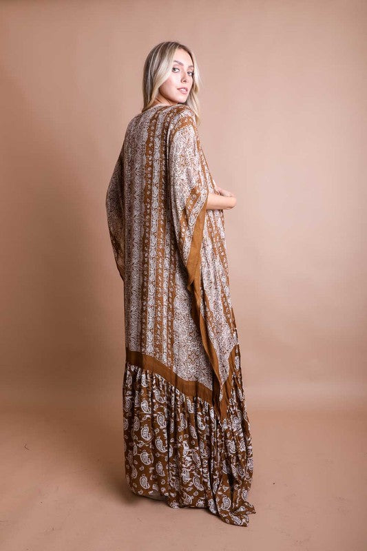 This sheer kimono is your ideal companion when you want to feel like you’re floating through life. Designed for the woman who loves to layer with ease and grace! This free flow Kimono stands out from others as it goes from a minimalist top and transitions beautifully into a rich paisley print as it flows toward the hem, creating a look that’s both modern and timeless. The oversized fit and mid-length sleeves add to the laid-back, breezy vibe, making it the ultimate piece for both lounging and living. 