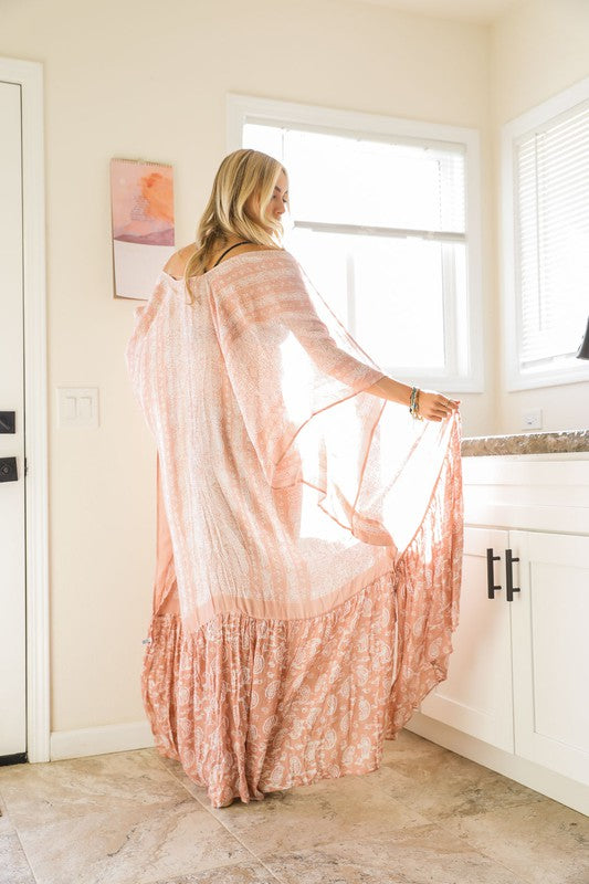 This sheer kimono is your ideal companion when you want to feel like you’re floating through life. Designed for the woman who loves to layer with ease and grace! This free flow Kimono stands out from others as it goes from a minimalist top and transitions beautifully into a rich paisley print as it flows toward the hem, creating a look that’s both modern and timeless. The oversized fit and mid-length sleeves add to the laid-back, breezy vibe, making it the ultimate piece for both lounging and living. 