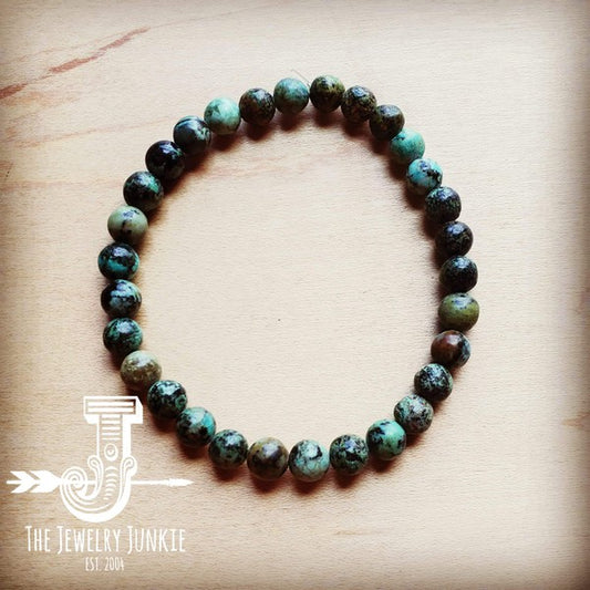 Looking for handcrafted jewelry where no two are identical? This Strech Bracelet can be Mix and Matched to create your own unique stack! The Black African Turquoise has a distinctive blue-green color with black or brown matrix inclusions, often featuring earthy greens and blues mixed with dark veins, makes a visually unique and highly valued African turquoise bracelet! Essentially this bracelet is variety of jasper with a mottled appearance. 