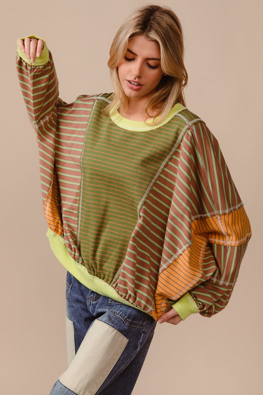 Oversized Sweatshirt -The Bold Mix Sweatshirt – Dare to Be Different.  Bold, vibrant, and impossible to ignore—this oversized color block and striped sweatshirt is made for the free spirit who isn’t afraid to stand out. With its striking mix of daring hues, it’s more than just a sweatshirt; it’s a statement. Whether you're layering it or rocking it solo, this eye-catching piece is sure to turn heads and add energy to any look. Don’t wait—this one will move fast, and you won’t want to miss out on this!