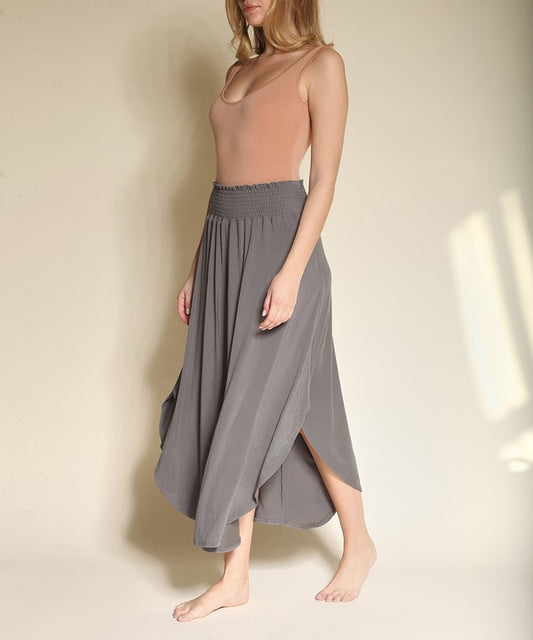 Experience ultimate comfort and effortless style with our luxurious Organic Bamboo Maxi Skirt. Crafted from a dreamy blend of organic bamboo and soft, stretchy spandex, this skirt offers an incredible drape and moves with you, offering a flattering fit that feels as good as it looks. The smocked elastic waist hugs gently, giving you all-day ease, while the flowing silhouette adds a graceful, boho touch to any outfit. This is a savvy choice for those who are eco-friendly or have skin conditions.