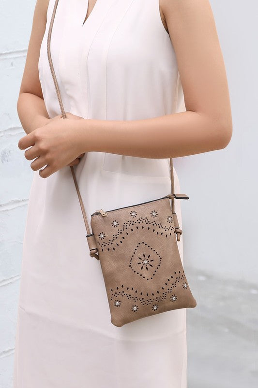 The Sustainable and Sleek Crossbody Bag works perfectly for days when much is not needed to carry to get through the day. Crafted with a supple soft Vegan leather material and gorgeous eyelet design. Roomy enough to fit a phone, keys, and a small wallet comfortably. This bag allows anyone to be hands-free and go about the day with ease and style.