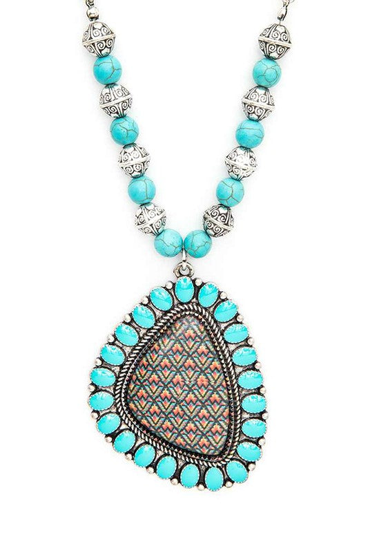 There’s something about a bold pendant that feels like a secret. The kind that’s just waiting to be discovered—maybe on a late-night stroll under the stars, or at that quirky café you've been meaning to try. The Aztec Printed Large Pendant Necklace, with its 24" chain, carries the spirit of adventure. It's the necklace you wear when you're ready to break free from the ordinary and step into something a little more you.

Crafted with care, the necklace lead and nickel compliant, so you can it all day with no