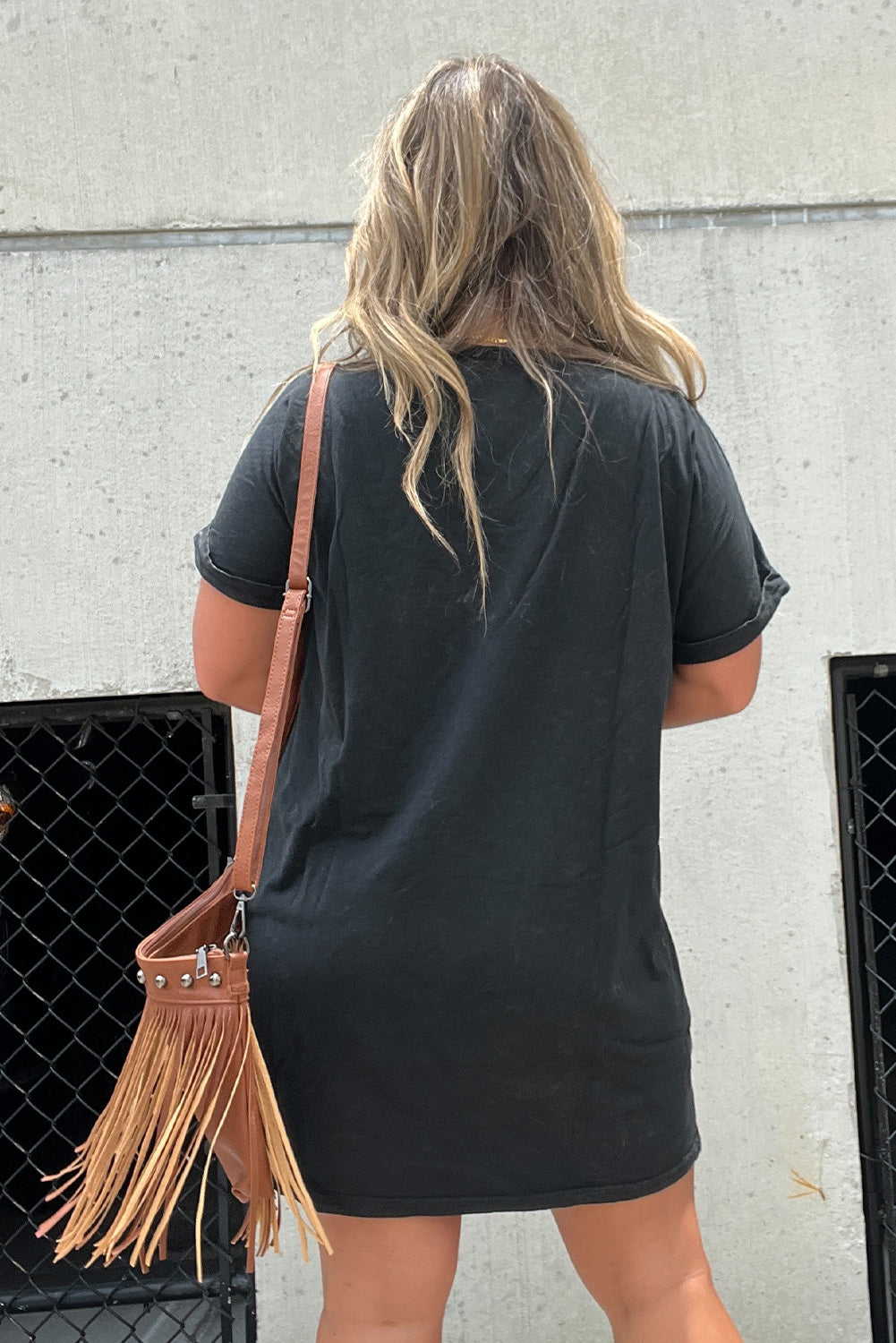 As the weather warms up this western music graphic t-shirt dress is going to be a fun and effortless pullover to pair with your favorite boots and accessories to get out the door!&nbsp; This short sleeve, black t-shirt dress can be worn out during the day running errands, meeting with friends, and then going to a festival or concert with a layer at night. Need a fringe handbag or a layer to complete the style? Just check out our handbag section and the layer/ outdoor section to complete the outfit.