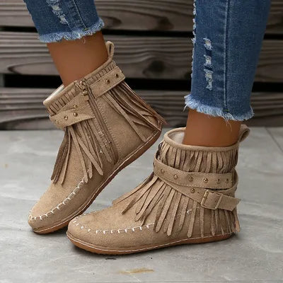Step into the spirit of adventure with these Fringe Studded Suede Flat Boots. Designed for the free-spirited woman who craves comfort and style, these boots blend western ruggedness and bohemian flair. With soft, rich suede, fringed accents flowing with every step, bold rivets adorning the straps, these cowboy booties have a rebellious sparkle that are available in several earthy tones. Just right for a woman not afraid to make a statement.