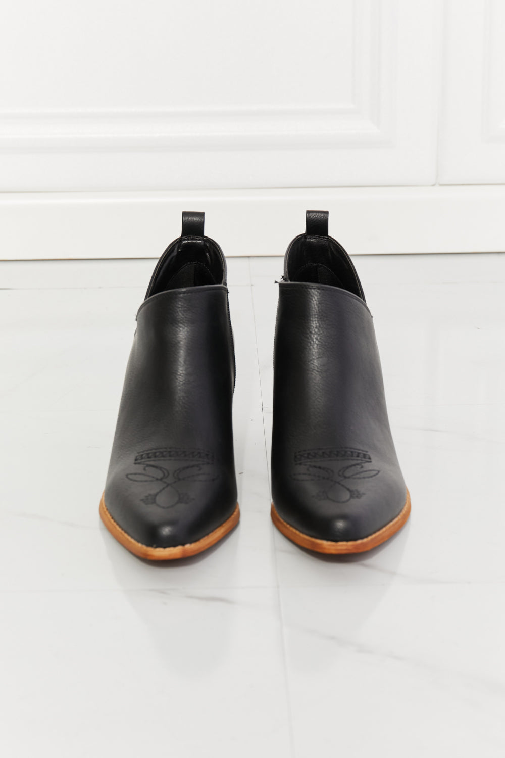 We've fallen in love with these crossover cowboy booties, with 2.5-inch stacked heel in black. These stunning crossover cowboy booties are designed to deliver both style and comfort. They feature a pointed toe, bold stitching, and a block heel for effortless all-day wear. They transition well from season to season. The embroidered design provides a classic touch and these cowboy booties pair well with distressed jeans or your favorite dresses. 