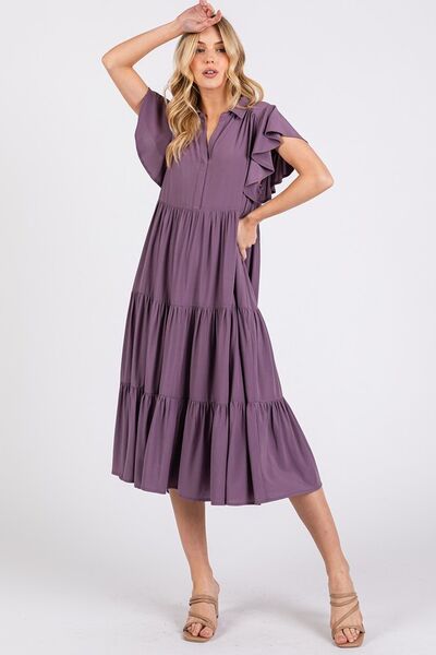 A ruffle sleeve, collared V-neck, tiered midi dress provides a simple feminine style. The tiered design creates a layered and textured look, adding dimension and flow. The midi length falls below the knee, making it versatile for both casual and more dressed-up occasions. Whether you're enjoying a sunny day in the park or headed to a rooftop dinner, this dress pairs effortlessly with sandals, boots, or layered jewelry for a carefree yet stylish vibe. 