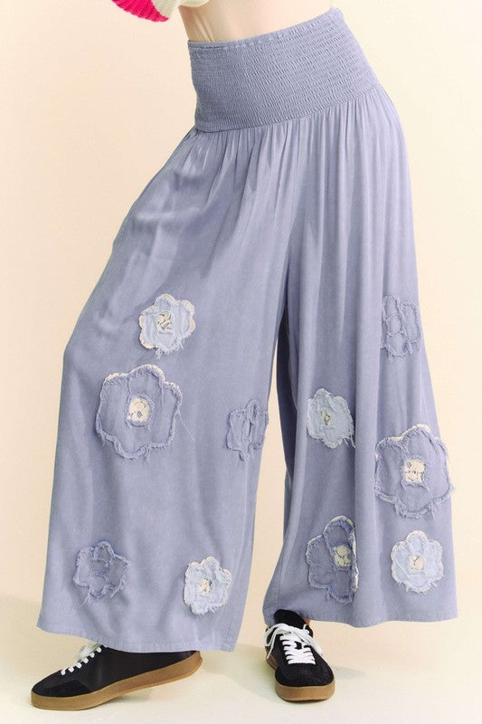 The Smocked Waist Flower Patch Wide Leg Pants offer a carefree, free-spirited vibe.

Here we go! Wide Leg Pants, check, smocked, flattering smocked fit, check, flower patches that bring the charm and whimsy, check, effortless style for any laid-back day, check! Ideal for any boho style wardrobe.