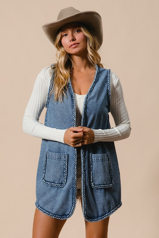 Denim Vest - with Pockets - "Cowgirl Spirit Braided Vest"
The braided vest is a perfect blend of classic Western style and unique craftsmanship. It is not a normal vest, it’s a statement! Featuring intricate braided trim along the edges, it brings a unique touch of rustic charm that sets you apart from the crowd. Are you headed to a rodeo, a concert, or out for a casual day?  It adds a sense of adventure to your wardrobe, making you feel ready for anything. Your wardrobe is waiting.